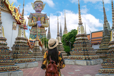 Asian travellert woman walking in Pagoda area in Wat Pho near Thailand grand palace and wat phra kaew in Bangkok city, Thailandの写真素材