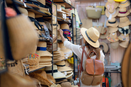 Asian woman travel and shoping in straw hat shop in Platinum market in Bangkok city, Thailandの写真素材