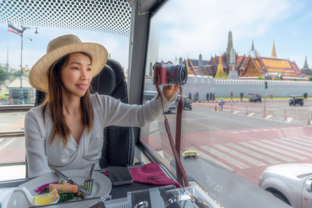 Asian traveller woman take a lunch on the restaurant bus between city tour by bus with wat phra kaew and Thailand grand palace bangkokの写真素材