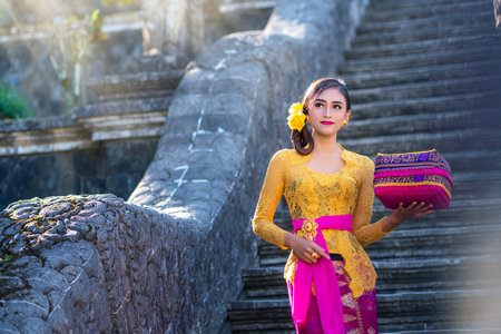 Indonesian girl with traditional costumn dance in bali temple, indonesiaの写真素材