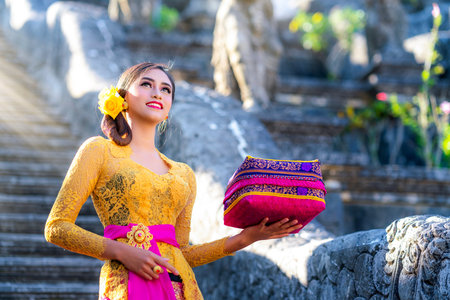 Indonesian girl with traditional costumn dance in bali temple, indonesiaの写真素材