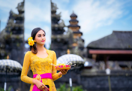 Indonesian girl with traditional costumn dance in bali temple, indonesiaの写真素材