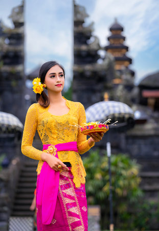 Indonesian girl with traditional costumn dance in bali temple, indonesiaの写真素材