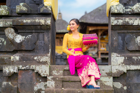 Indonesian girl with traditional costumn dance in bali temple, indonesiaの写真素材