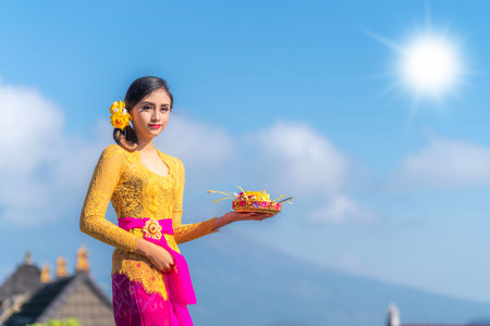 Indonesian girl with traditional costumn dance in bali temple, indonesiaの写真素材
