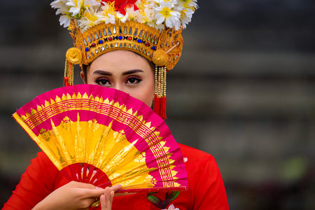 Indonesian girl with traditional costumn dance in bali temple, indonesiaの写真素材