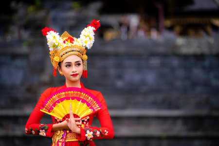 Indonesian girl with traditional costumn dance in bali temple, indonesiaの写真素材