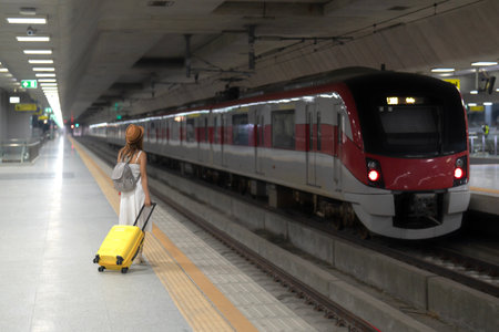 traveller woman walking at Krung Thep Aphiwat Central Terminal or Bang Sue Central station is the central passenger terminal in Bangkok and the current railway hub of Thailand with travel bagの写真素材