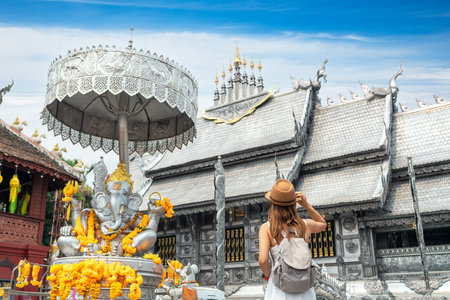 Asian woman traveller in white dress travel in Silver church in wat sri suphan temple in Chiang mai city, Tahilandの写真素材