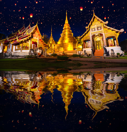 wat phra singh temple in night time in raining season in Chiang mai city, Thailandの写真素材