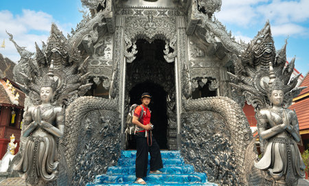 Asian man traveller in white dress travel in Silver church in wat sri suphan temple in Chiang mai city, Tahilandの写真素材