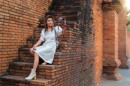Asian traveller woman walking on the street of Chiang mai old wall in Chiangmai city, Thailandの写真素材