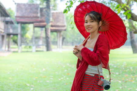 Asian traveller woman in traditional lanna dress in temple for take a photo in Chiang mai city, Thailandの写真素材