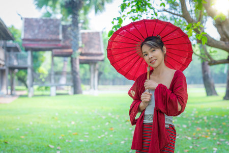 Asian traveller woman in traditional lanna dress in temple for take a photo in Chiang mai city, Thailandの写真素材