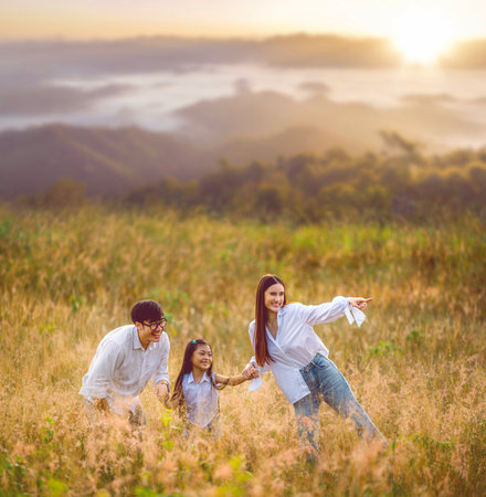 Asian traveller family walking on morning sunrise time togather go to camping for sleep by tent at Chiang mai, Thailandの写真素材