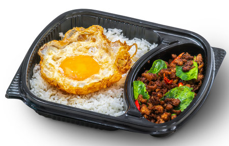 Basil Rice with Fried Egg in lunch box to order from food delivery app, noline order from application for Thai traditional foodの写真素材