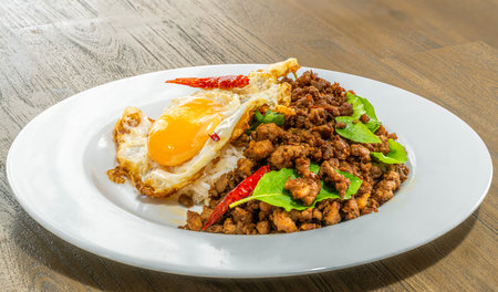 Basil Rice with Fried Egg in white dish to order from food delivery app, noline order from application for Thai traditional foodの写真素材