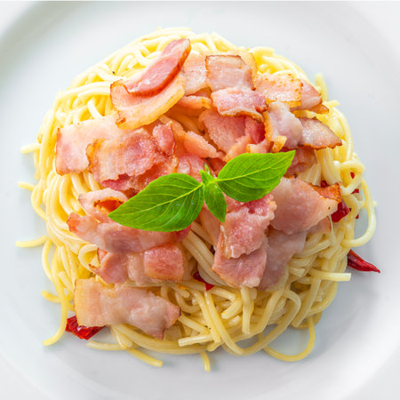Spaghetti aglio e olio, pasta with chili and garlic and bacon on white plateの写真素材