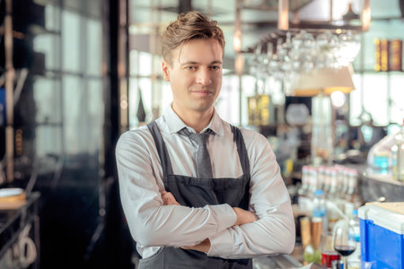 Asian man bartender and his customer talking in roof top bar and  restaurant with beverage counterの写真素材
