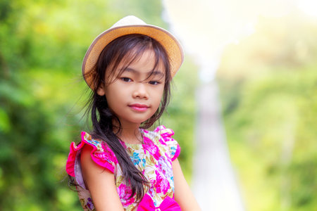 Asian girl play and enjoy in green meadow with bubble, kid and natureの写真素材