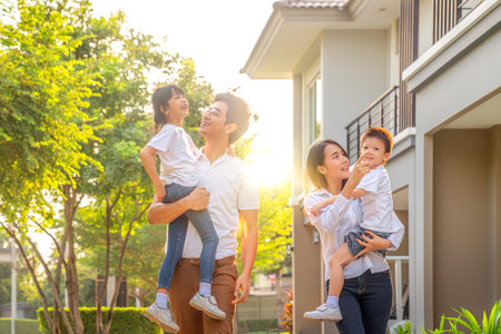 Asian family walking togather with Mother father and daughter in home village, Park in Bangkok city, Thailand