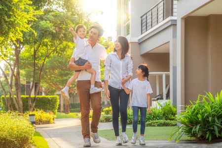 Asian family walking togather with Mother father and daughter in home village, Park in Bangkok city, Thailandの写真素材