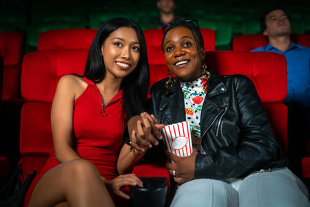 lesbian lgbt lgbtq couple sweet and enjoy movie in Cinema,  woman couple entertainment in theater.の写真素材
