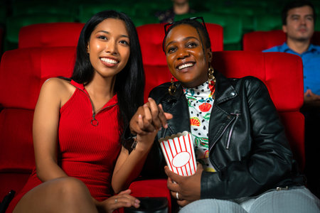 lesbian lgbt lgbtq couple sweet and enjoy movie in Cinema,  woman couple entertainment in theater.