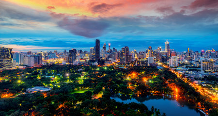 Lumpini Park and Bangkok city the with sunset sky on the roof top bar and restaurantの写真素材