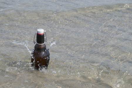 A beer bottle with snap-top, to cool down in the seaの写真素材