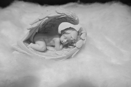 Sleeping little angel on a cloudの写真素材