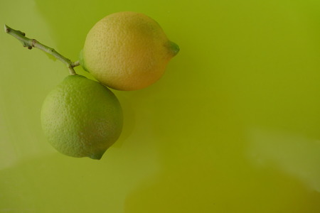 Two lemons on green backgroundの写真素材