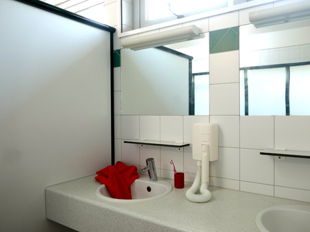 Modern sanitary facilities in a public building, Germany, Europe The public, clean sanitary room has a large selection of sinks with mirrors, hairdryers, sinks and shower stallsの写真素材