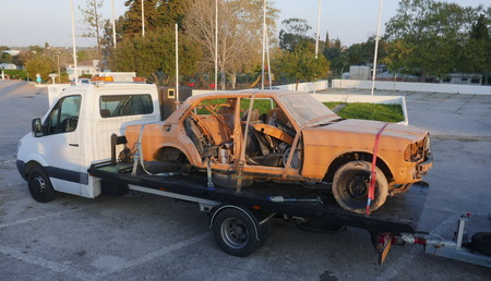 Transport of an old, broken, rusty car, for the purpose of restoration and repair. Defective car on tow truck.の写真素材