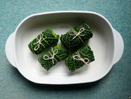 4 cabbage rolls. Savoy cabbage, a vitamin-rich main course. Close up, isolated on white backgroundの写真素材