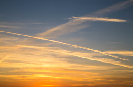 Beautiful panorama of the evening blue sky with colored clouds. Sunset. Beautiful yellow and orange...