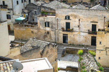 The ancient city of Matera, carved into the rock. Old stone blocks and streets of the city. In...