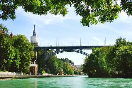 Beautiful panorama of the city of Bern and the emerald river Aare. Big bridge over the river. Summer...