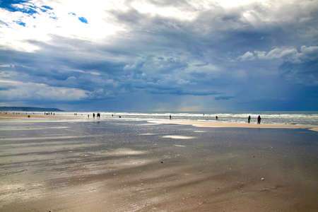 The tide of the English channel (La Mancha) on a Sunny summer day. The beach in Deauville.の写真素材