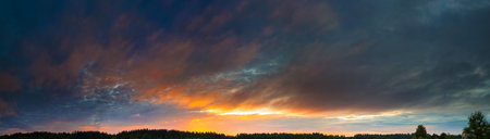 Panorama of the sky with beautiful colored whimsical clouds. Evening sky. White night. Sunlight on...