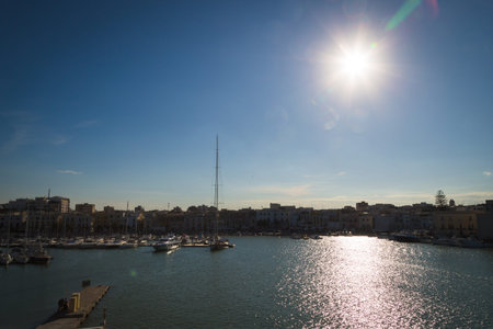 View of the city of Trani on a Sunny day from the sea. Italy. Contour light. Sunny path on the...