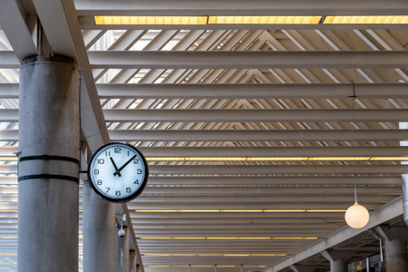 Circle black and white classic public clock at the train station. Represent business time.