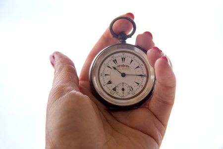 close up of hands with vintage pocket watch retro