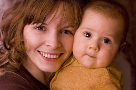Mother keeps son in his handsの写真素材