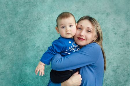 Mother keeps son in his handsの写真素材