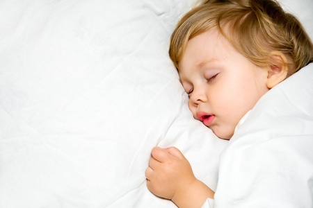 portrait of a close-up, infant lying on the bedの写真素材