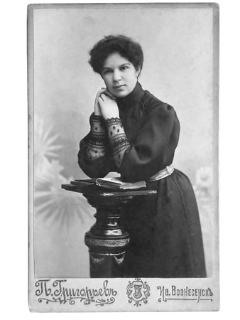 Vintage portrait of woman early 20 century on background.