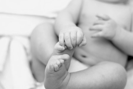 feet of the child in the hands 