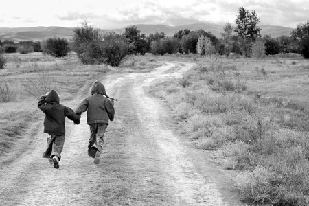 girl and boy standing or running on the roadの写真素材