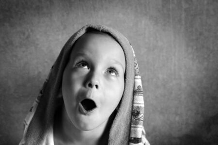 the boy looks up in surpriseの写真素材